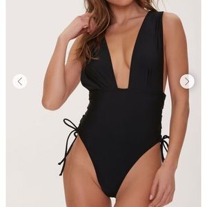 One piece stringy black plunging swimsuit